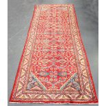 A Hamadan runner, North-west Persia, mid/late 20th century, the red field with overall flowering