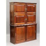 A late Victorian Aesthetic Movement walnut side cabinet, fitted with brass hinges and handles, the