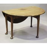 A George III mahogany circular drop-flap supper table, raised on tapering legs and pad feet,