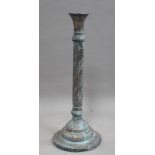 A late 19th century Middle Eastern patinated brass stand, worked with overall spiralling bands of