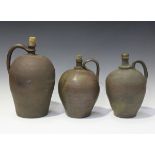 A group of three Continental earthenware oil jars of ovoid form, heights 35cm to 28cm.Buyer’s