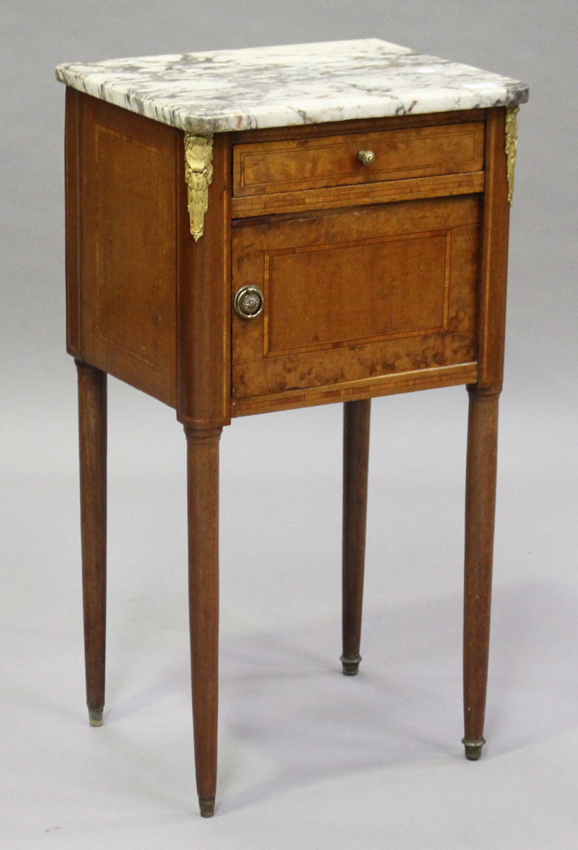 An early 20th century French walnut bedside cabinet with marble top and gilt metal mounts, height