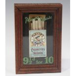 A Player's Navy Cut advertising display case, enclosing a pack of cigarettes and inscribed in green,