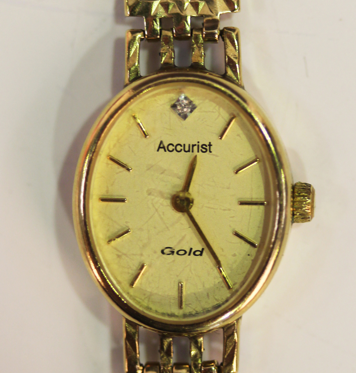 An Accurist 9ct gold oval cased lady's wristwatch, the signed dial with gilt baton hour markers,