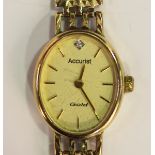 An Accurist 9ct gold oval cased lady's wristwatch, the signed dial with gilt baton hour markers,
