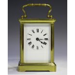 An early 20th century French brass cased carriage timepiece with eight day movement, the glazed case