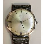A Marvin steel circular cased gentleman's wristwatch, the signed silvered dial with baton hour