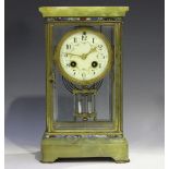 An early 20th century French brass, onyx and champlevé enamel four glass mantel clock with eight day