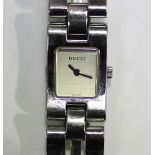 A Gucci stainless steel lady's bracelet wristwatch with signed rectangular silvered dial, the case