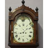 An early 19th century mahogany longcase clock with eight day movement striking on a bell, the cast