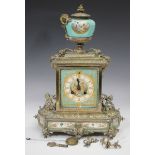 A late 19th century French silvered brass and porcelain mantel clock with eight day bell-strike