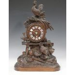 A late 19th century Black Forest cased walnut mantel clock with French eight day movement striking