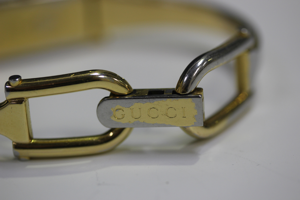 A Gucci gilt metal lady's bangle wristwatch with signed rectangular cream coloured dial, case - Image 3 of 4