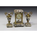 An early 20th century French marble and brass four glass mantel clock garniture, the clock with