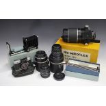 A collection of cameras and photographic equipment, including an Exida-Mat Reflex model B-L