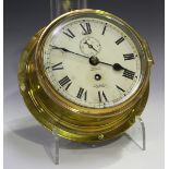 An early 20th century brass circular cased ship's style wall timepiece, the movement with platform