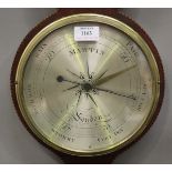 A George III mahogany wheel barometer with hygrometer, alcohol thermometer and silvered dials,
