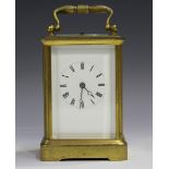 An early 20th century brass cased carriage clock with eight day movement repeating and striking