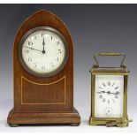 A late 19th/early 20th century brass cased carriage alarm clock with eight day movement striking