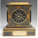 A Victorian walnut and ebonized mantel clock with eight day movement striking on a bell via an