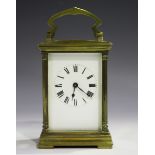 An early 20th century French brass cased carriage timepiece with eight day movement, the white