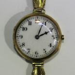 A 9ct gold circular cased lady's wristwatch, the enamelled dial with Arabic numerals, import mark