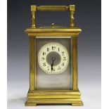 A late 19th/early 20th century brass cased carriage clock with eight day movement repeating and