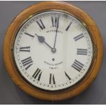 A late 19th century beech circular cased wall timepiece, the painted dial with Roman hour numerals