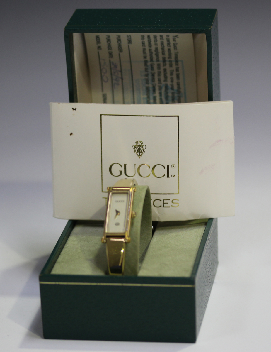 A Gucci gilt metal lady's bangle wristwatch with signed rectangular cream coloured dial, case - Image 2 of 4