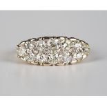 A gold and diamond ring in a boat shaped design, mounted with variously cut diamonds, the mount