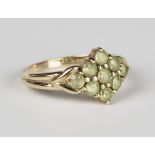 A 9ct gold and pale green gemstone set nine stone cluster ring in a lozenge shaped design, ring size