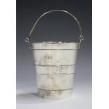 A late Victorian silver ice bucket of tapering coopered form with swing handle, the underside