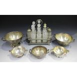 A late Victorian plated eight-bottle cruet stand, length 29.5cm, together with five plated bowls.