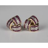 A pair of 9ct gold, ruby and diamond earstuds in an interlooped trefoil shaped design, with post and
