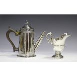 An Edwardian silver cream jug with scroll handle, on a pedestal foot, London 1901 by Wakely &