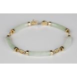 An Asian 14ct gold mounted jade bracelet, the five curved baton shaped links alternating with