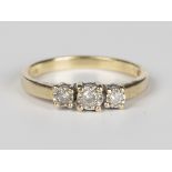 A 9ct gold and diamond three stone ring, mounted with a row of circular cut diamonds, detailed '.