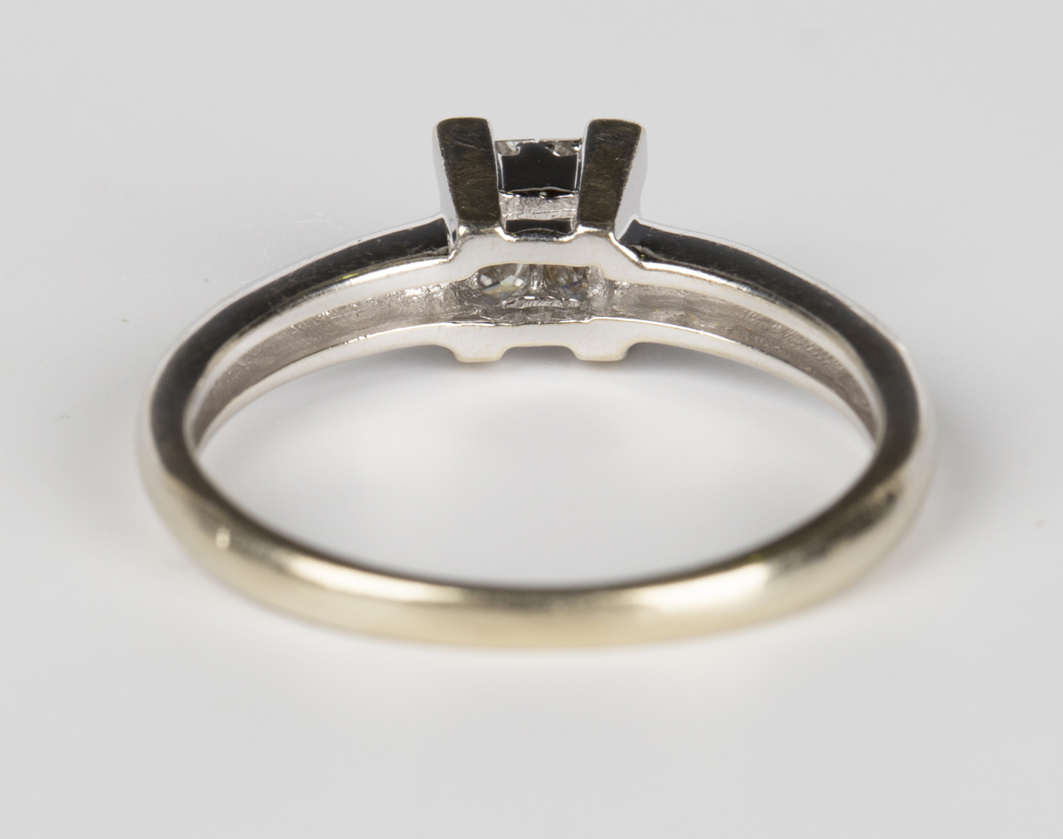 An 18ct white gold and diamond ring, mounted with four princess cut diamonds, detailed '0.20 18K - Image 3 of 3