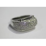 A white gold and diamond ring, the raised bombé style centre mounted with circular cut diamonds,