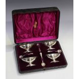 A set of four late Victorian silver table salts, each of oval boat shaped form on a pedestal foot,