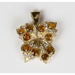 A gold, diamond and citrine pendant of foliate form, mounted with circular cut diamonds and
