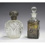 A late Victorian silver mounted cut glass perfume bottle and stopper, the silver hinged cover with