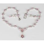 A silver, pink and colourless gem set necklace, the front mounted with the two principal pear shaped