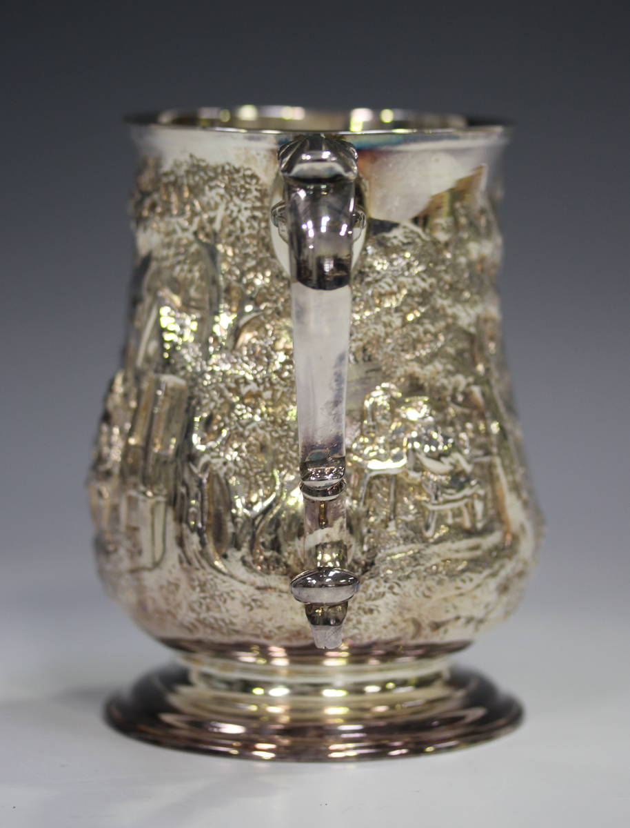 A George III silver tankard, the baluster body later embossed with a scene of figures seated and - Image 2 of 5