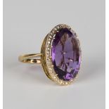 A gold, amethyst and rose cut diamond oval cluster ring, claw set with the oval cut amethyst