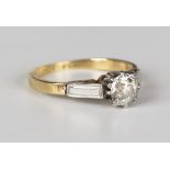 A gold, platinum and diamond single stone ring, claw set with a cushion cut diamond between platinum