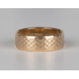 A gold wide band wedding ring with chequered decoration, detailed '585', ring size approx O.Buyer’