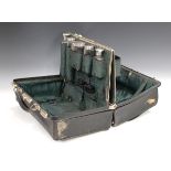 An Edwardian black leather Gladstone vanity bag, the interior fitted with five silver and cut