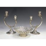 A pair of 20th century Spanish silver twin-branch candelabra, each raised on an oval base, height