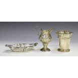 A George III silver cream jug of ogee baluster form, later embossed with a rural scene, on a